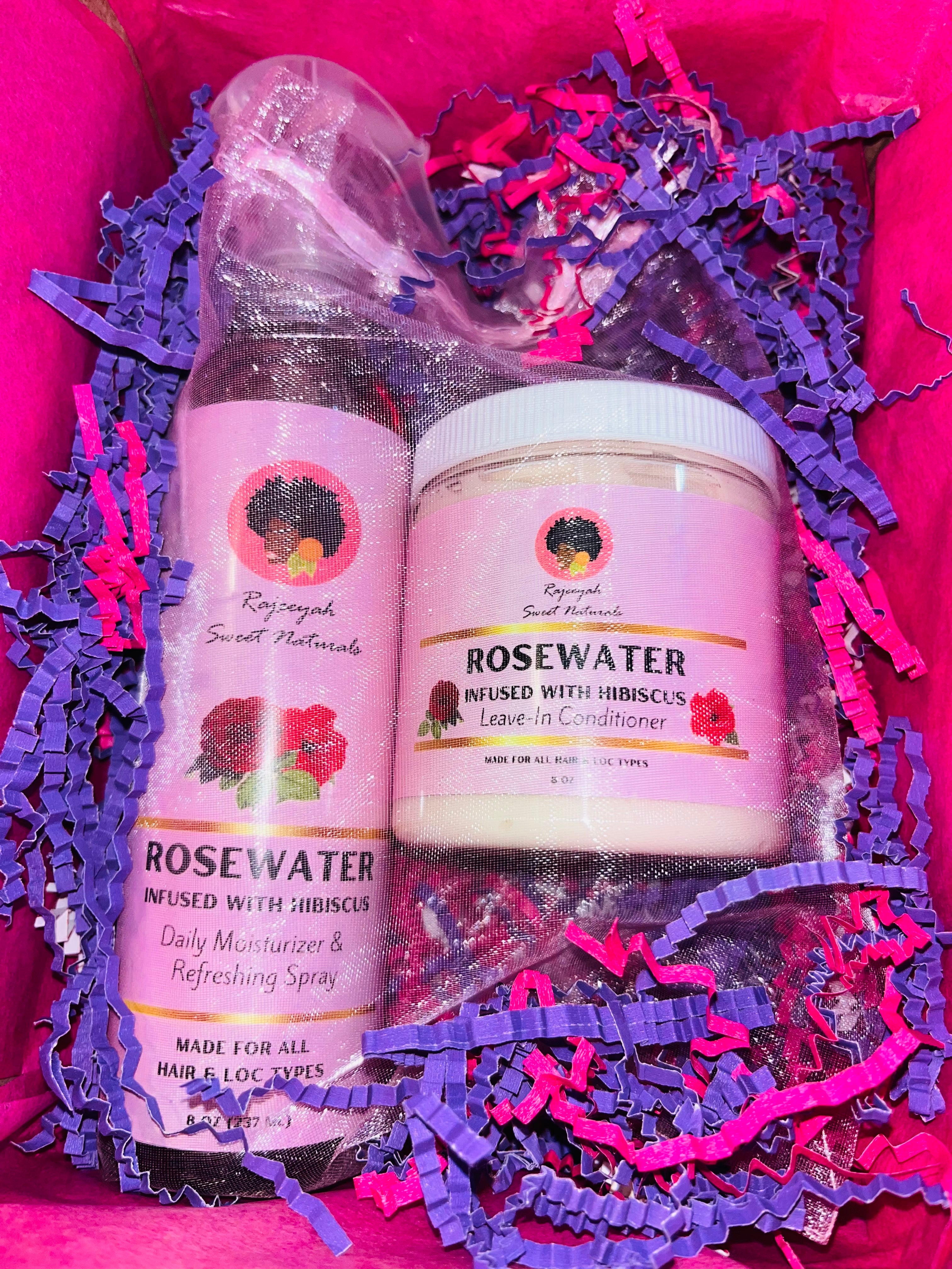Two skincare products, a spray and a jar, on purple and pink shredded paper with a pink background.